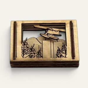 Front view of the Anchorage AK Matchbox Miniature showing a floatplane over mountains in layered wood