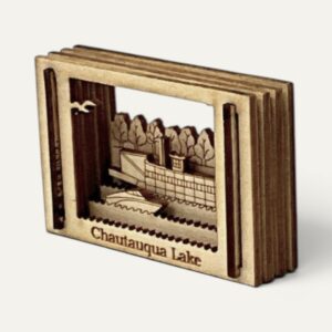 Opposite angle of the Chautauqua Lake Matchbox Miniature with steamboat, motorboat and trees