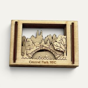 Front view of the Central Park NY Matchbox Miniature showing a stone arch bridge and city skyline in layered wood