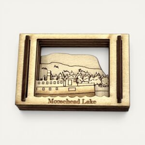 Front view of the Moosehead Lake ME Matchbox Miniature showing a steamboat and evergreen shoreline in layered wood