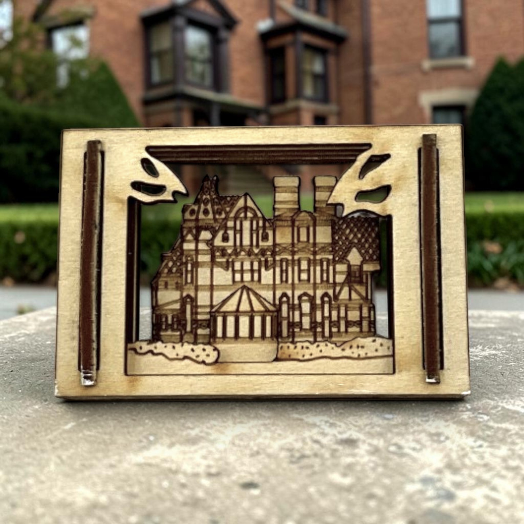 Mark Twain House Matchbox Miniature photographed in front of the brick house in Hartford