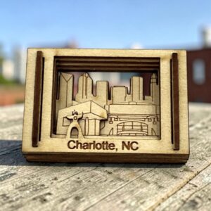 Charlotte, NC laser-cut wood Matchbox Miniature on a weathered rooftop table